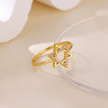 Gold ring with a geometric design on a light beige background