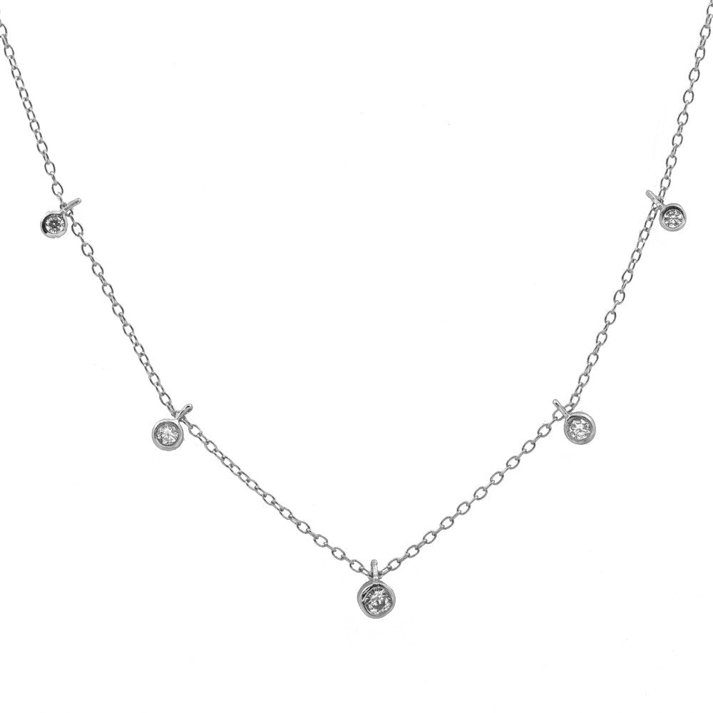 A silver-toned delicate necklace featuring a fine chain with five small circular bezel-set clear stones, including one larger central pendant, displayed on a solid white background.