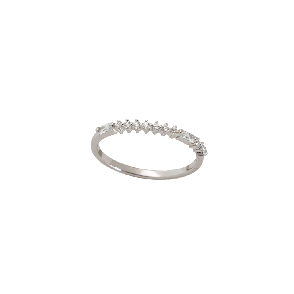 Silver ring with small diamonds on a light gray background