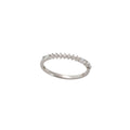 Silver ring with small diamonds on a light gray background
