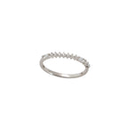 Silver ring with small diamonds on a light gray background