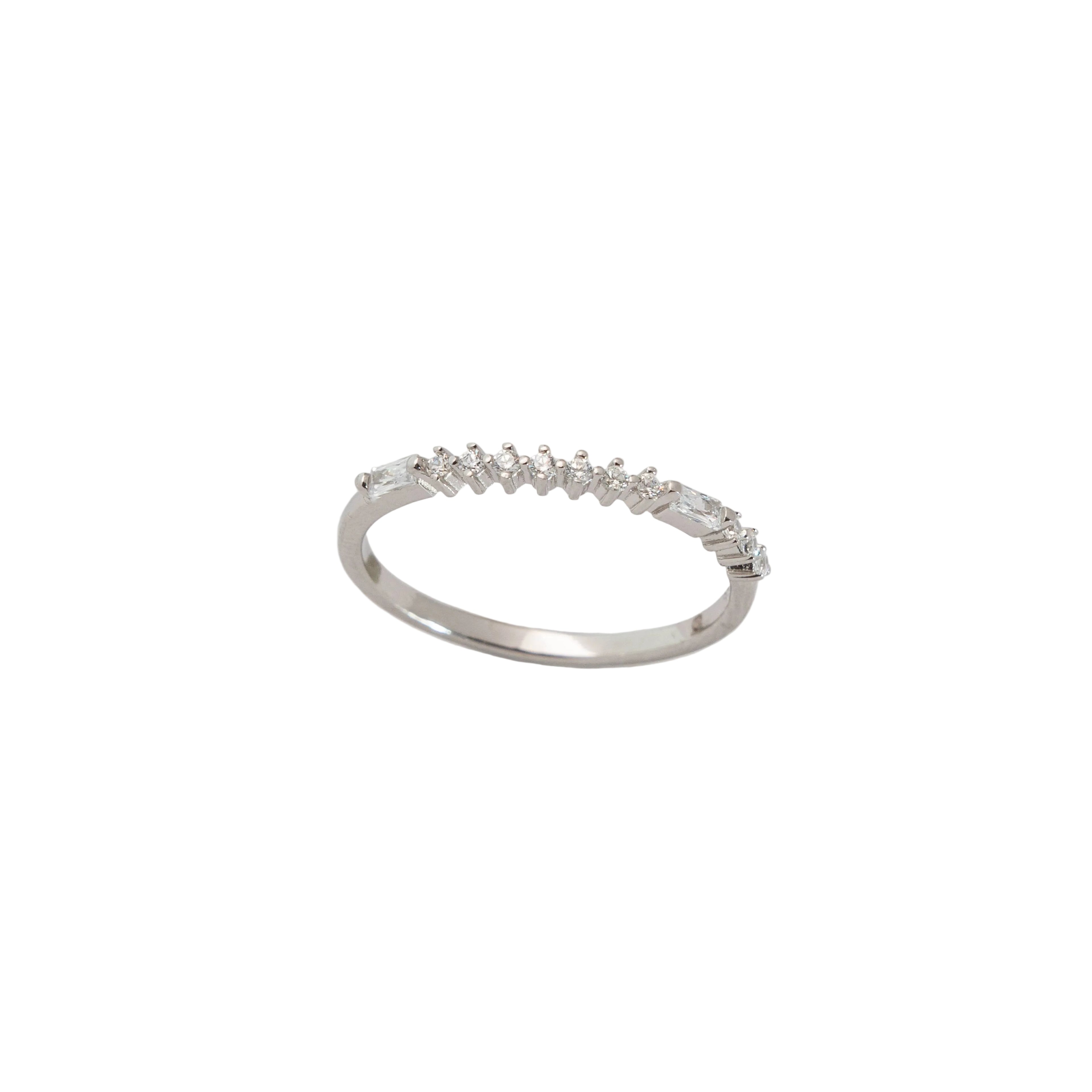 Silver ring with small diamonds on a light gray background