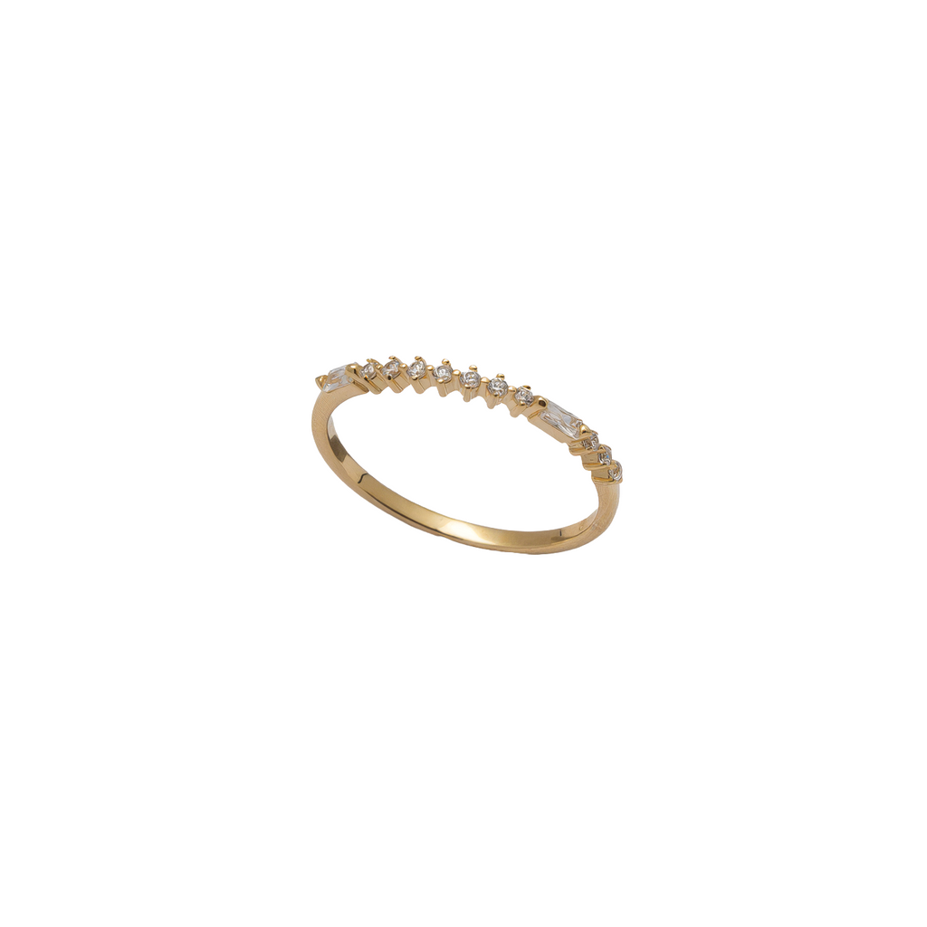 A delicate yellow gold ring featuring a row of small, clear baguette-cut gemstones set along the top band, photographed against a solid white background.