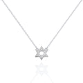 A delicate silver chain necklace featuring a Star of David pendant paved with small clear stones, displayed on a clean white background with a soft reflection below.