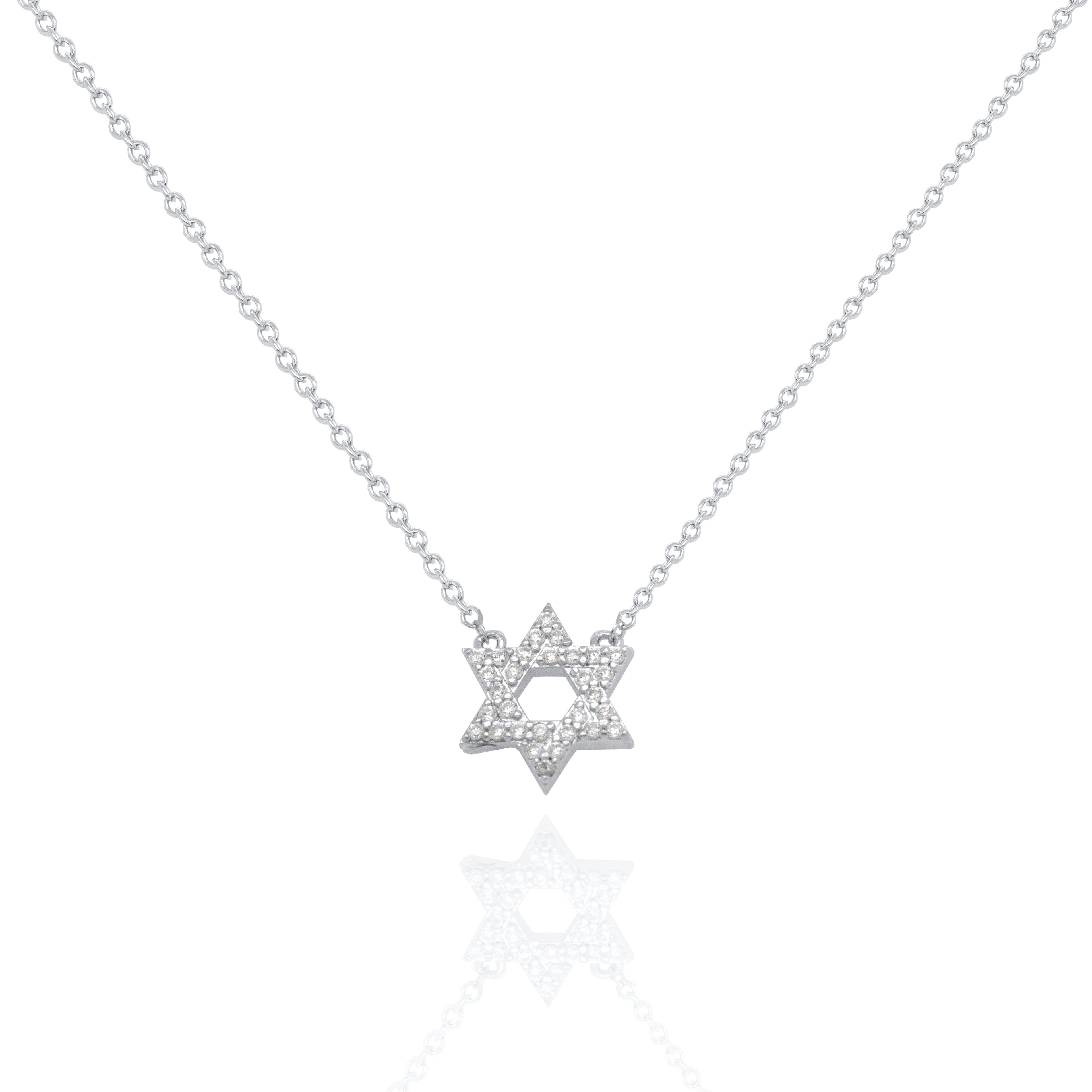A delicate silver chain necklace featuring a Star of David pendant paved with small clear stones, displayed on a clean white background with a soft reflection below.