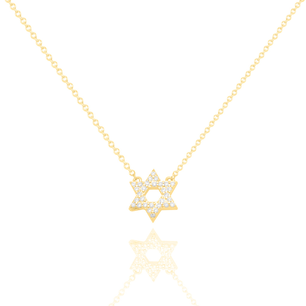 A delicate gold chain necklace featuring a Star of David pendant paved with small clear stones, displayed against a clean white background with a soft reflection below.