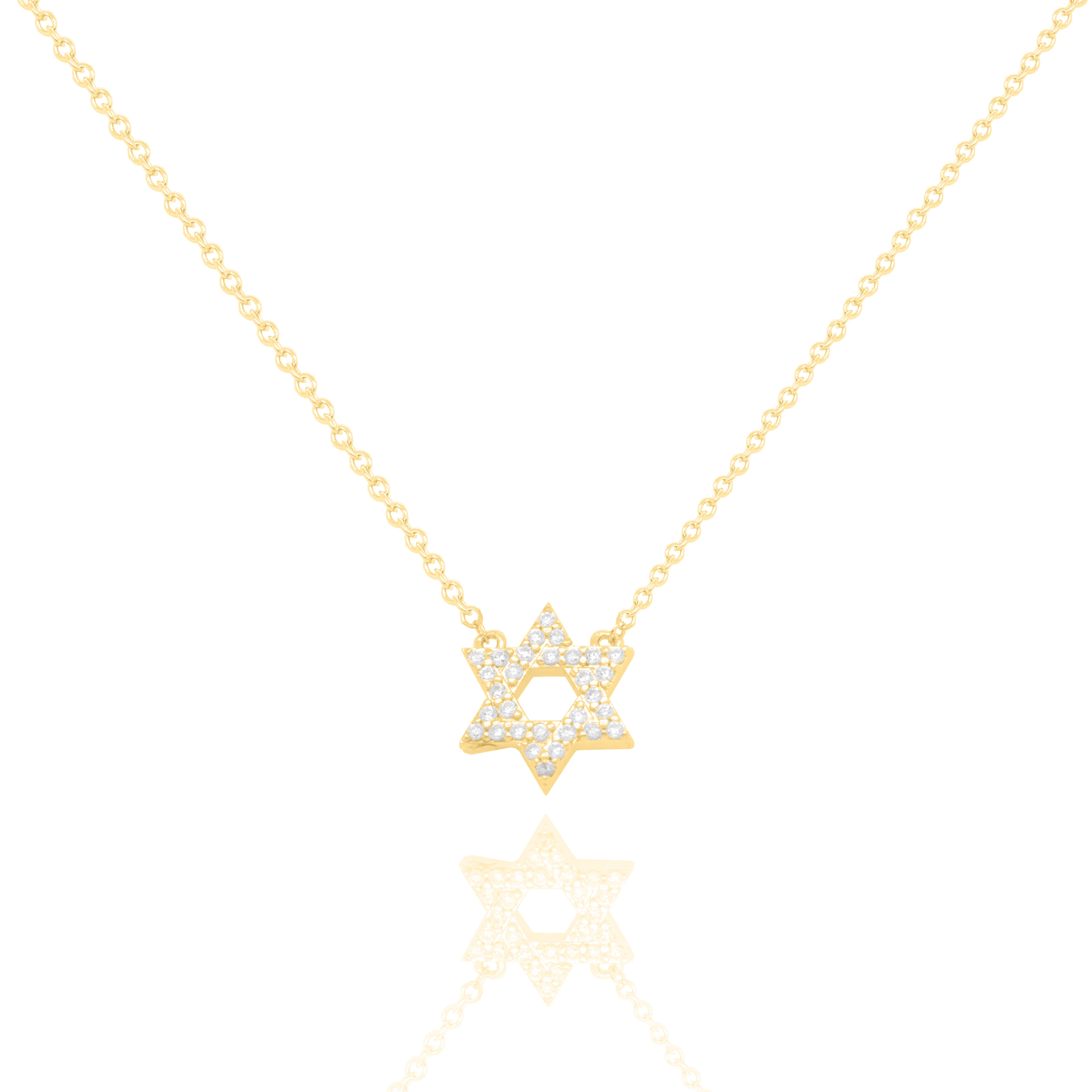 A delicate gold chain necklace featuring a Star of David pendant paved with small clear stones, displayed against a clean white background with a soft reflection below.