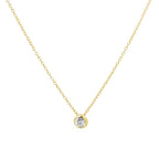 A delicate yellow gold chain necklace with a small round bezel-set clear gemstone pendant, shown against a plain white background.