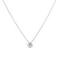 A delicate silver chain necklace with a small round bezel-set clear gemstone pendant, displayed against a solid white background.