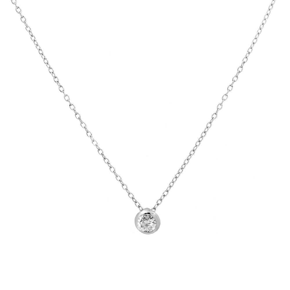 A delicate silver chain necklace with a small round bezel-set clear gemstone pendant, displayed against a solid white background.