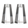 Two geometric glass candle holders on a white background