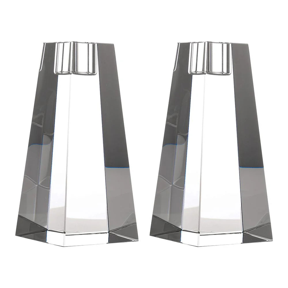 Two geometric glass candle holders on a white background