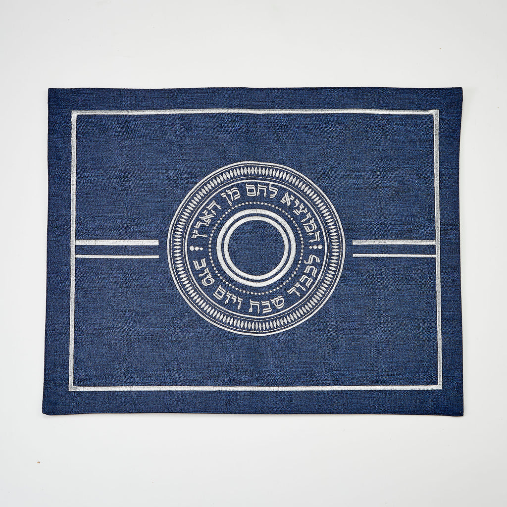 Blue challah cover with white circular design and text on a white background