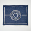 Blue challah cover with white circular design and text on a white background