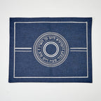 Blue challah cover with white circular design and text on a white background