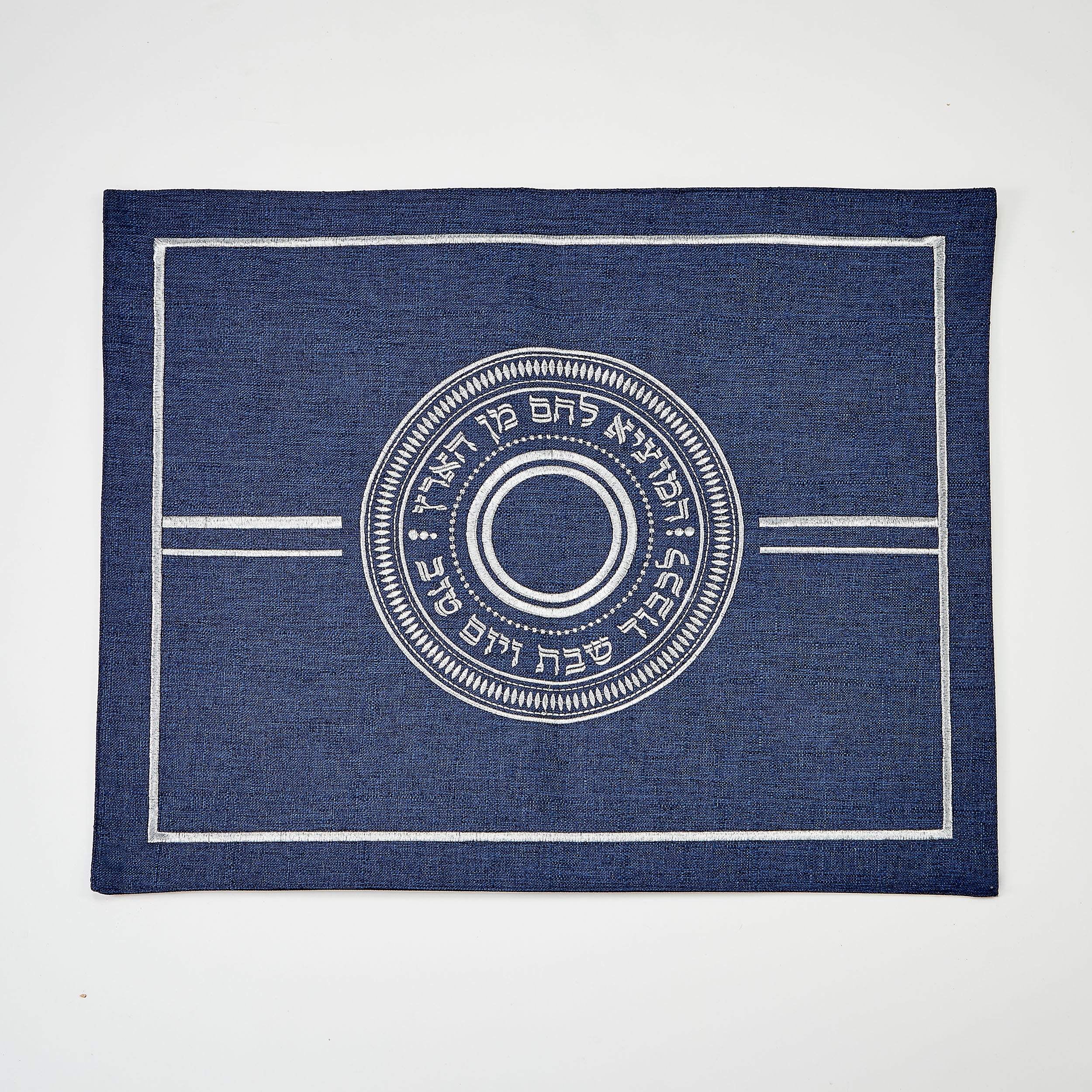 Blue challah cover with white circular design and text on a white background