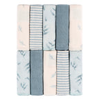 Set of folded towels with leaf pattern in pastel colors on a white background