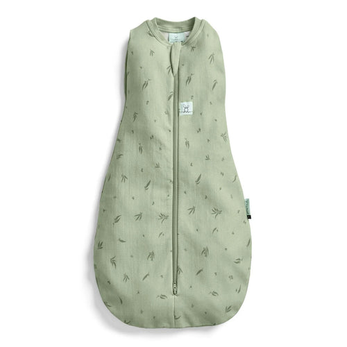 A sage green baby sleep sack with a subtle all-over leaf print, featuring a front zipper closure and a small white brand label on the chest.