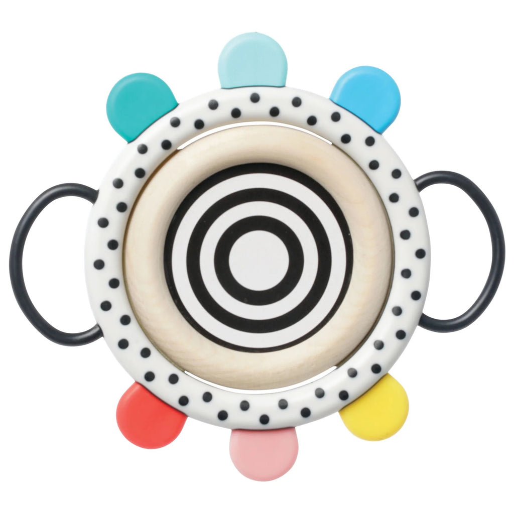 Colorful circular toy with black and white pattern on a white background