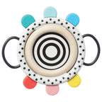 Colorful circular toy with black and white pattern on a white background