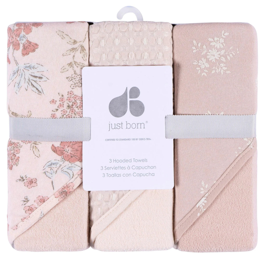 Set of three hooded towels with floral patterns and 'just born' branding.
