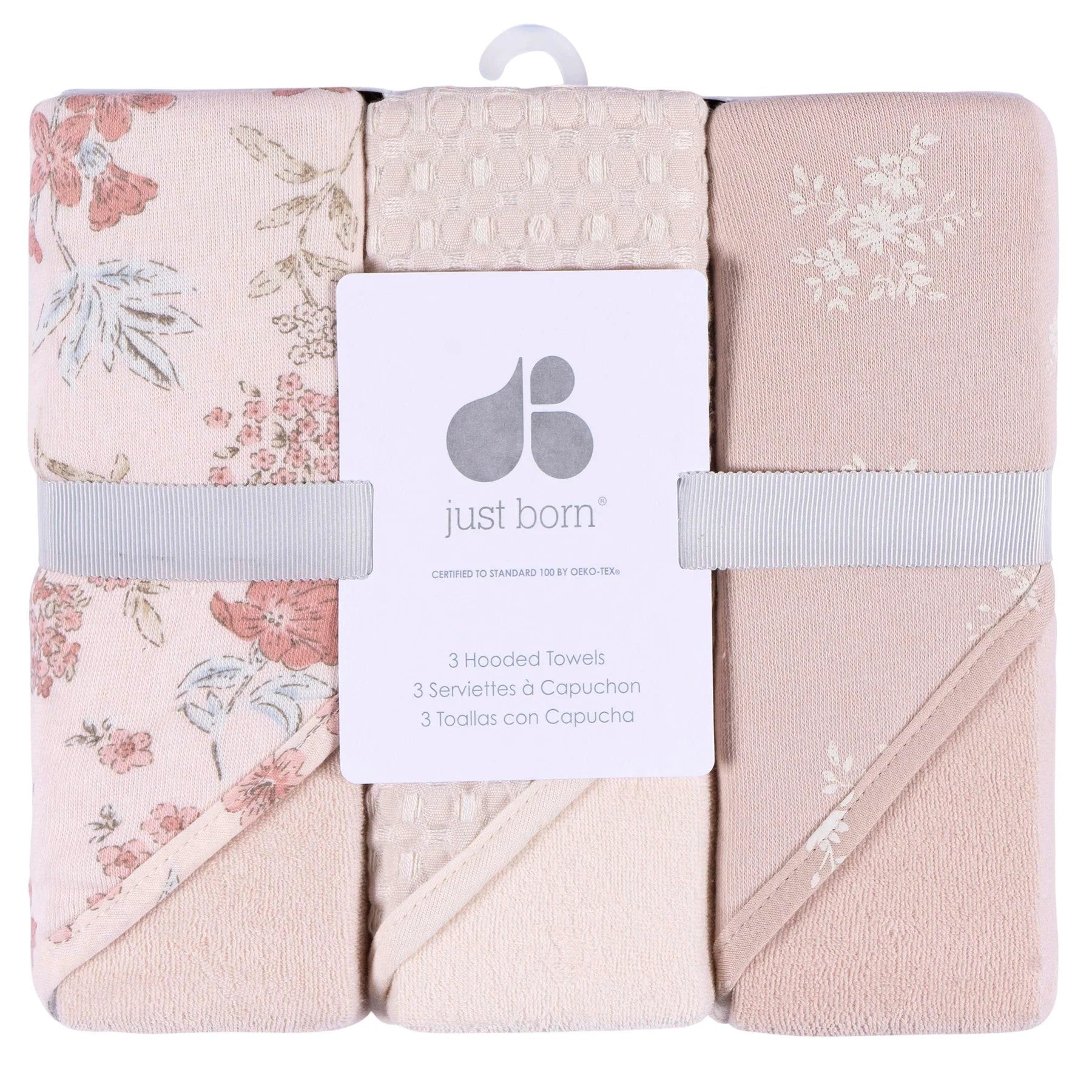 Set of three hooded towels with floral patterns and 'just born' branding.