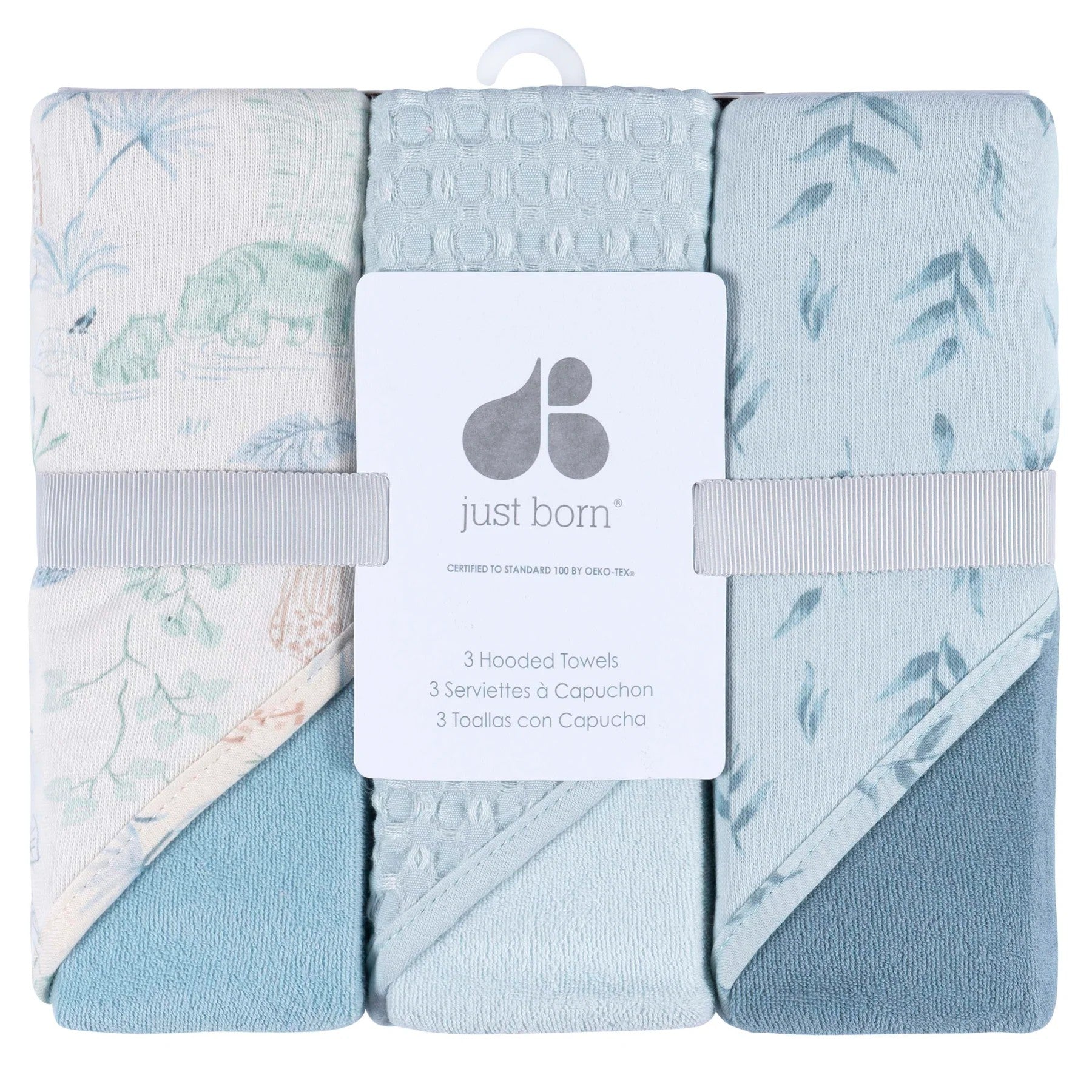 Set of three hooded towels with floral patterns in packaging, featuring 'just born' brand.
