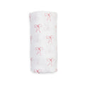 A white muslin swaddle blanket with a delicate red bow pattern, shown rolled up against a plain white background.