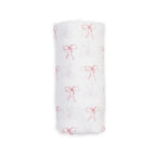 A white muslin swaddle blanket with a delicate red bow pattern, shown rolled up against a plain white background.