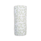 White swaddle blanket with green leaf pattern on a white background