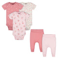Set of pink baby bodysuits and pants on a white background
