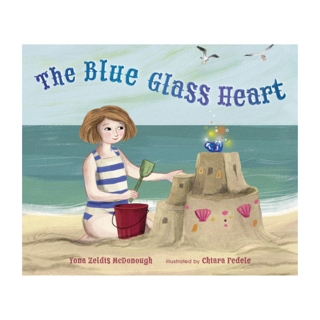 Children's book cover for 'The Blue Glass Heart' by Yona Zeldis McDonough, illustrated by Chiara Pedele, showing a young girl building a sandcastle on a beach with a blue glass heart floating above it.