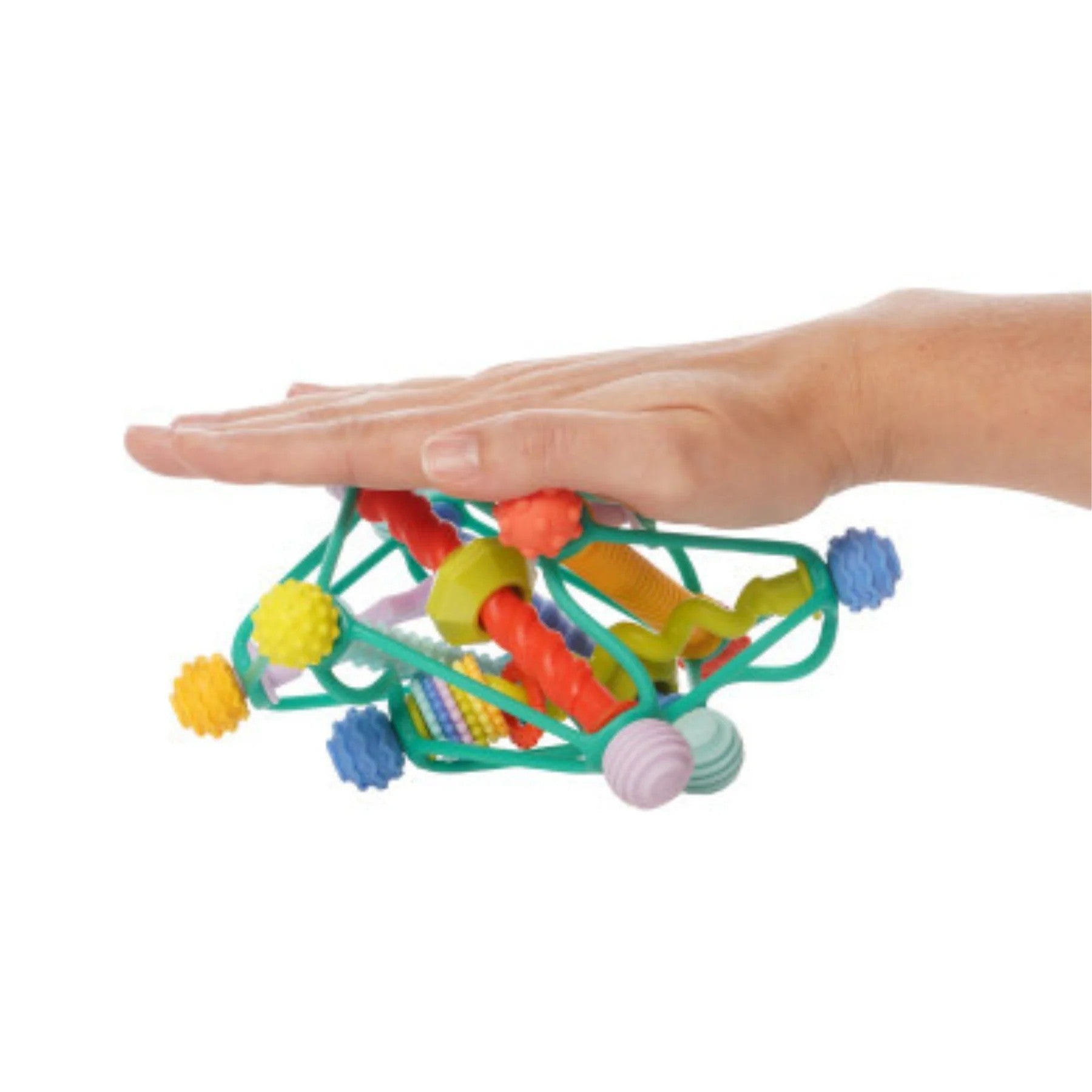Colorful toy with various textures held by a hand on a white background