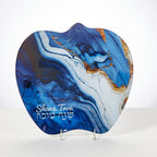 Blue and white marbled decorative plate with 'Shana Tova' text on a stand.