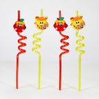 Four novelty spiral straws with cartoon fruit and honey character decorations on a white background.