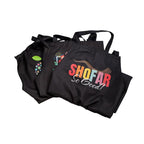 A set of 3 black aprons with humorous Rosh Hashanah phrases. 