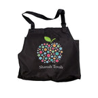 A black fabric bib-style apron featuring a colourful floral apple graphic and the text 'Shanah Tovah' printed on the front, shown against a plain white background.