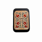 A rectangular black-framed art print with a beige background, featuring a hand-painted style design of red pomegranates and green leaves, with the text 'SHANA TOWA' in the center.