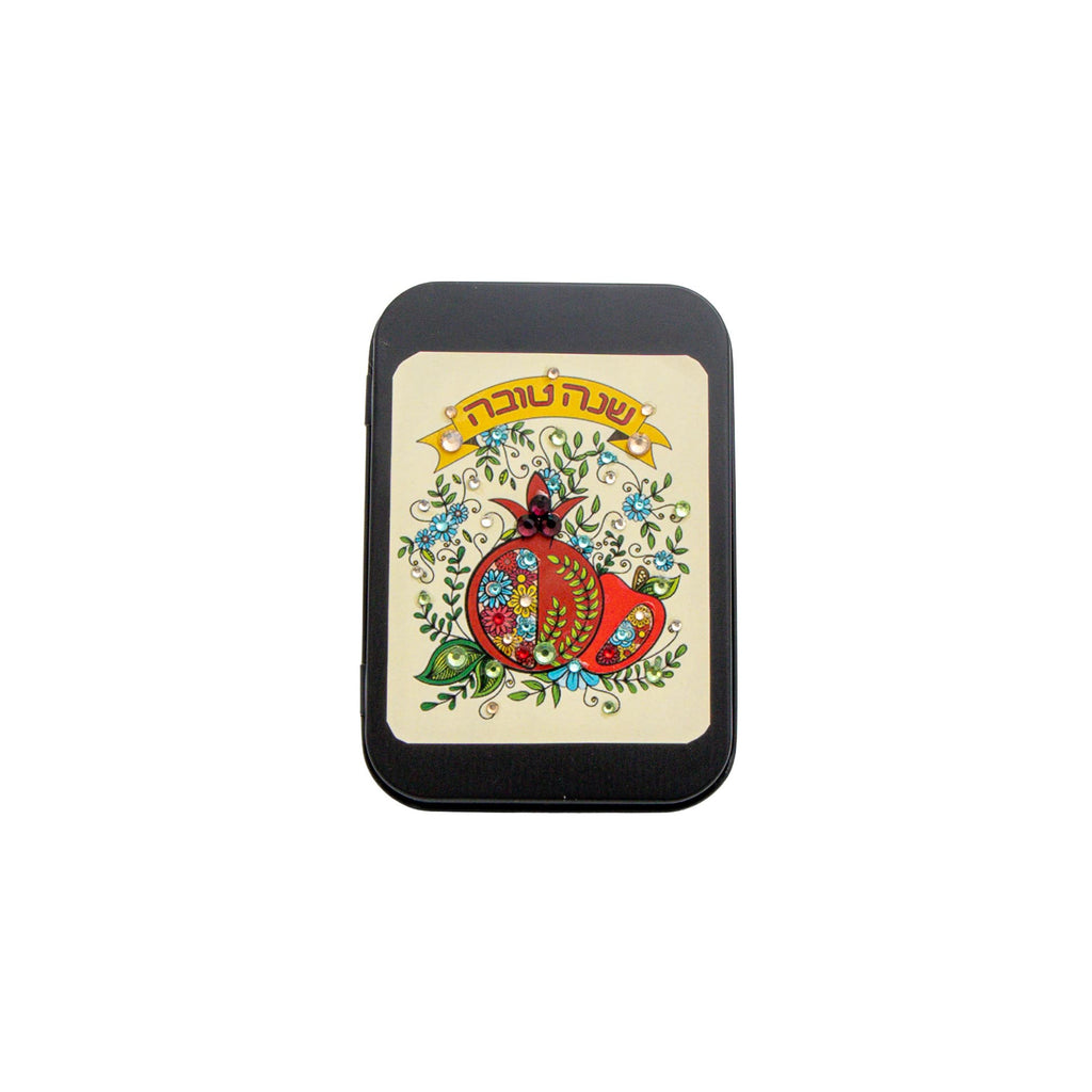 A small rectangular product centered on a plain white background. The item appears to be a black-bordered card, sticker, or label featuring a vintage-style illustration with a red hat, blue floral details, and yellow text at the top.