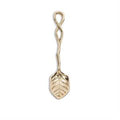 Gold-colored spoon with leaf design on a white background