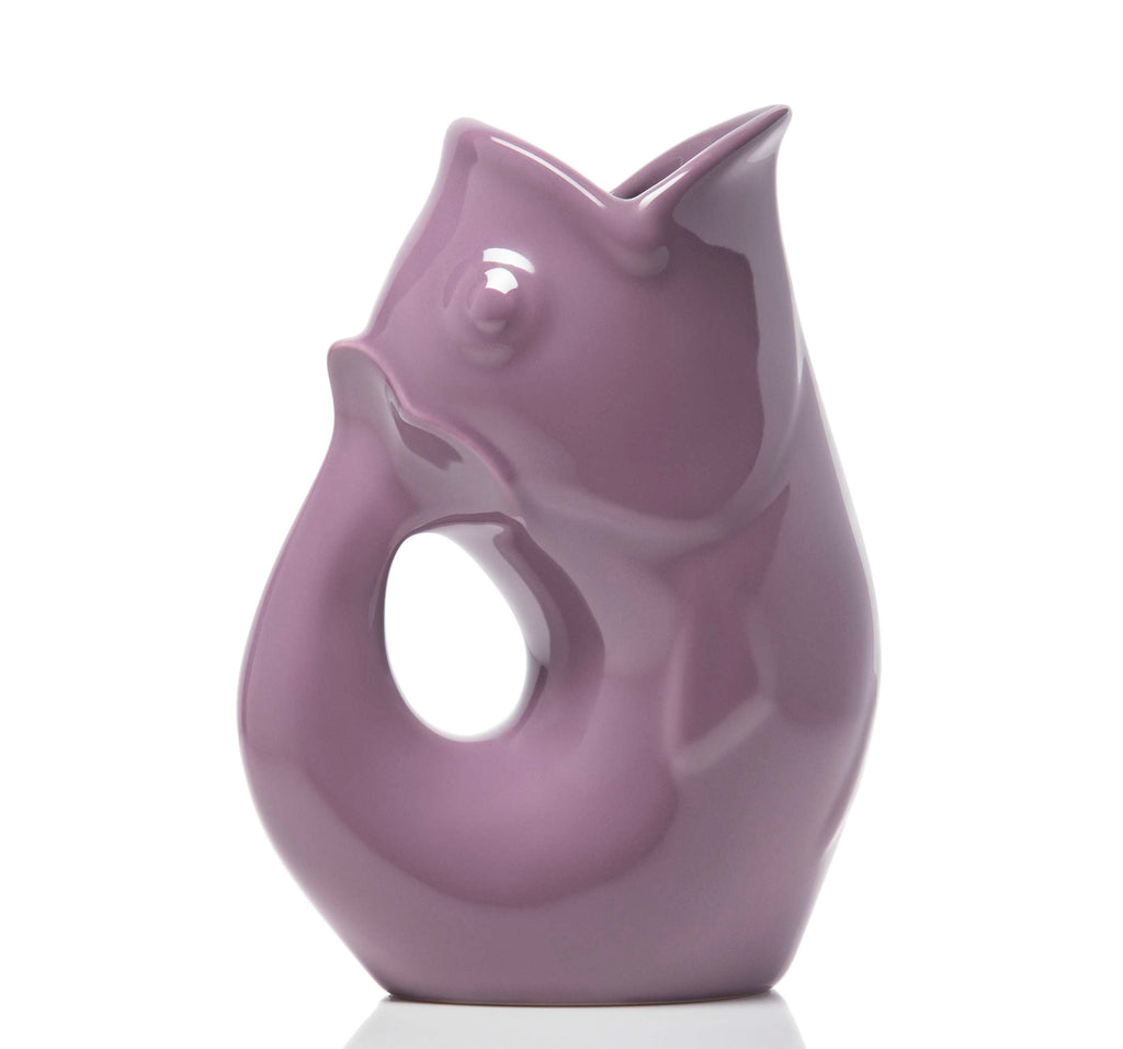 Purple ceramic vase shaped like a stylized fish on a white background