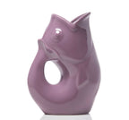 Purple ceramic vase shaped like a stylized fish on a white background