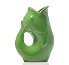 Green ceramic vase shaped like a fish on a white background