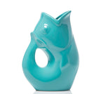 Turquoise ceramic vase shaped like a fish on a white background