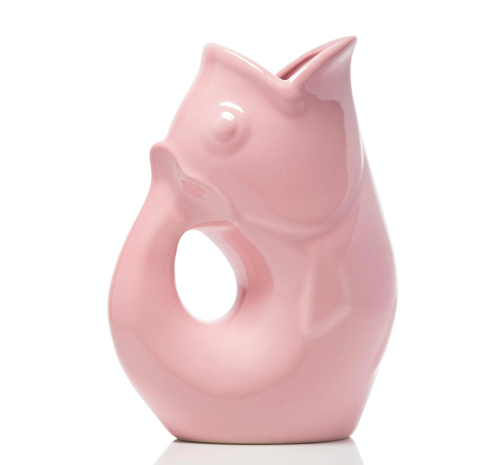 Pink ceramic fish pitcher on a white background
