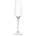 Clear champagne flute with pink heart patterns on a white background