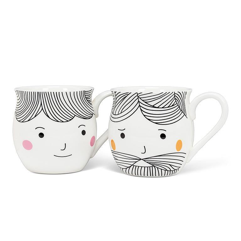 Two ceramic mugs with cartoon faces on a white background