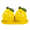 Two lemon-shaped salt and pepper shakers on a matching tray with a white background
