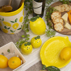 Table setting with lemons, cheese, and crackers on a tablecloth.