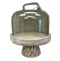 Decorative cake stand with glass dome on a white background